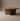 Clara Oval Walnut Dining Table, front view of solid walnut sculptural base