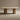 Beige dining table with cylindrical legs on a beige background