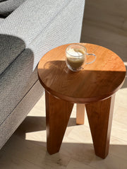 Close-up of Tres End Table's craftsmanship, highlighting natural wood grain in cherry finish