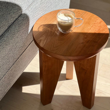 Close-up of Tres End Table's craftsmanship, highlighting natural wood grain in cherry finish