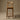Wooden bar stool against a brown background