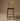 Wooden bar stool against a brown background