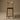 Wooden bar stool against a brown background