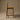 Wooden bar stool against a brown background