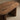 Close-up detail of the Ovali oval dining table in walnut