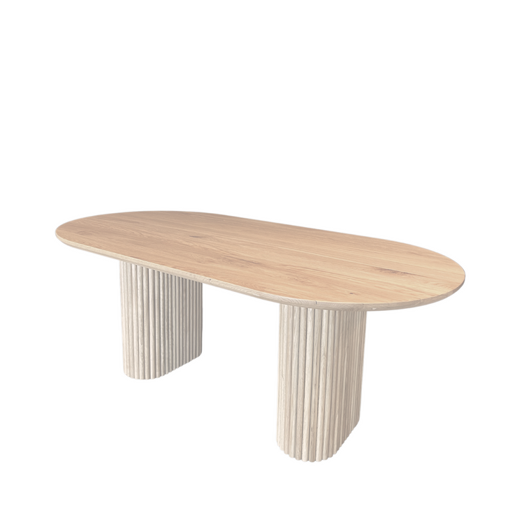 Side view of the OVALI oval dining table in maple, emphasizing the strength of the tambour bases and the timeless design of the table.