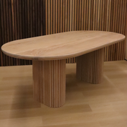 Exhibit of the OVALI oval dining table in a showroom, displaying its stylish design and superior Canadian craftsmanship.
