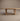 Pandi solid wood dining table in white oak, front view showing rectangular frame legs and low stretcher, handcrafted in Canada by ref.
