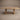 Pandi solid white oak dining table, elevated front view showing the thick square-edge top and frame base, by ref.