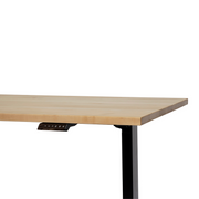 30" x 57" maple standing desk, showcasing the beauty of natural wood and made in Canada. The adjustable height makes it a perfect ergonomic addition to your home office.