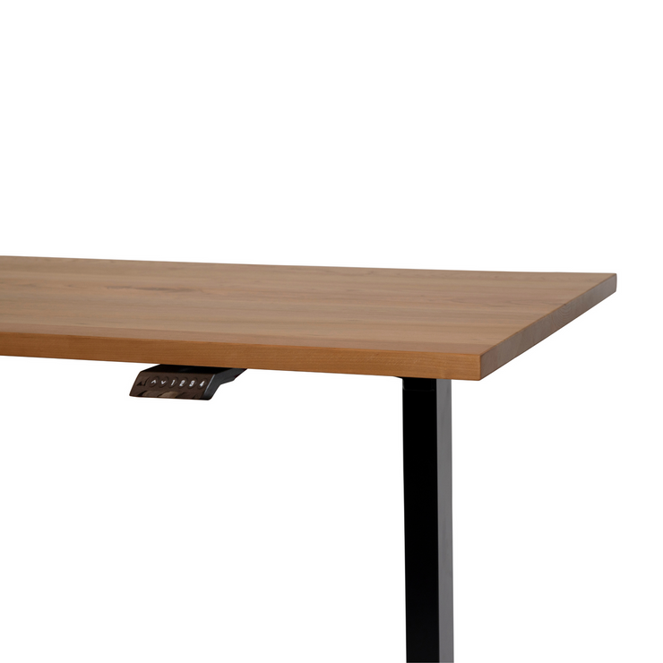 Ergonomically designed 30" x 57" cherry standing desk, set up in a home office with white legs. This piece highlights the beauty of Canadian-made wood desks.