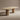 Wooden table with cylindrical legs on a beige background
