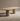 Wooden table with cylindrical legs on a beige background