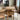 A light natural oak dining table with matching wooden chairs in a bright, modern dining room setting.