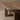 Close-up of a wooden shelf with a blurred background