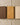 Three wooden samples in different colors on a textured beige background